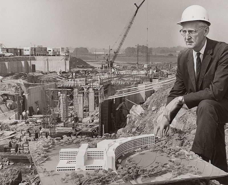Founding dean and CEO George Harrell, MD, pictured in 1966 with an architectural model, oversees initial construction of the Medical Center and College of Medicine.