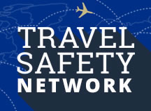 The Penn State University Travel Safety Network logo depicts the words Travel Safety Network in large block letters atop an outline map of the world with dotted flightpaths and a single plane above the lettering.