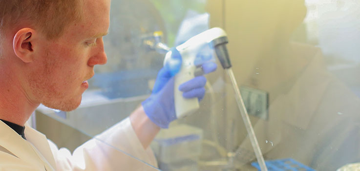 Matthew Lauver, a graduate student in the Penn State College of Medicine Department of Microbiology & Immunology, is seen at work in a department lab in July 2016.