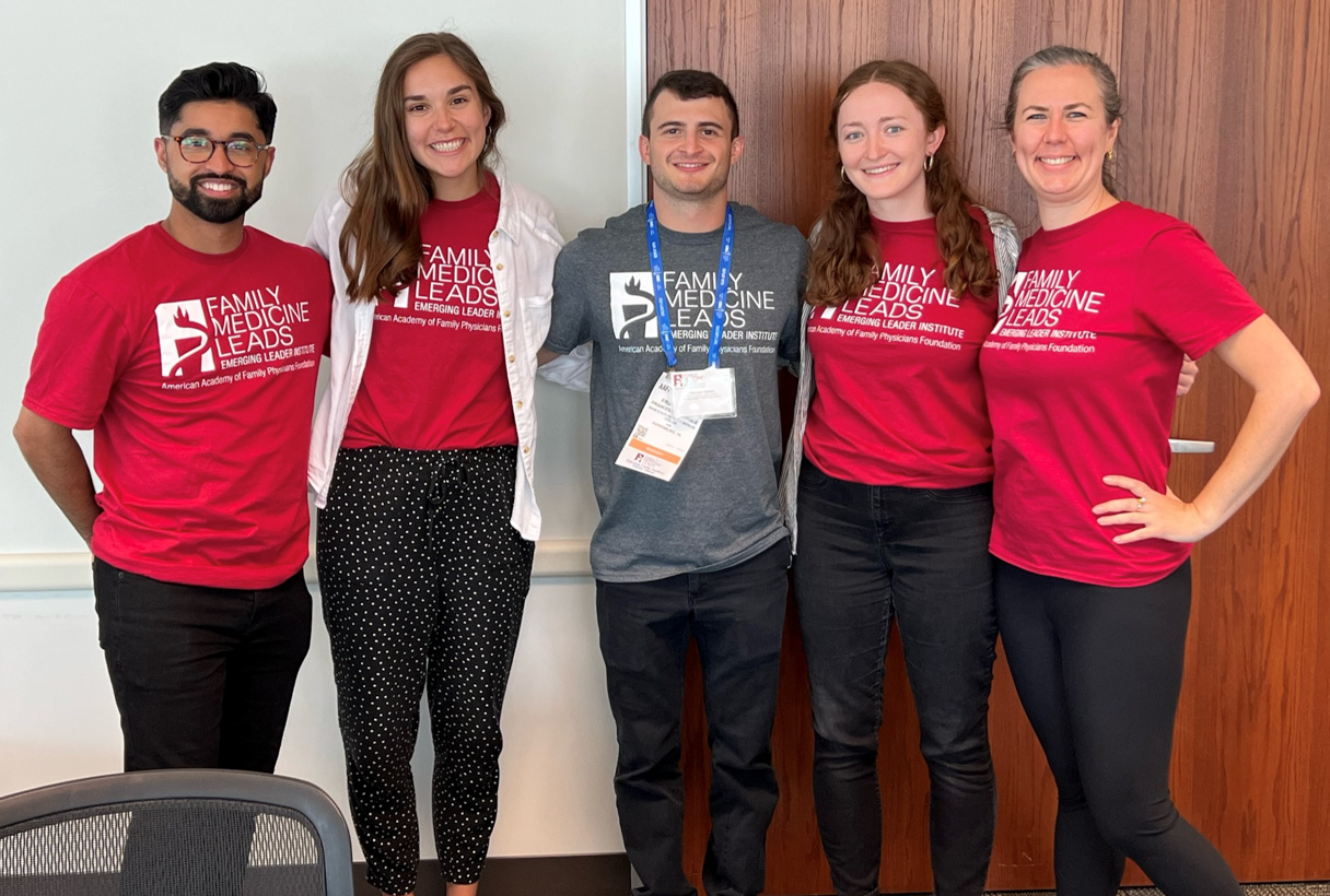 Four Family Medicine accelerated pathway students, wearing red and gray Family Medicine Leads shirts.