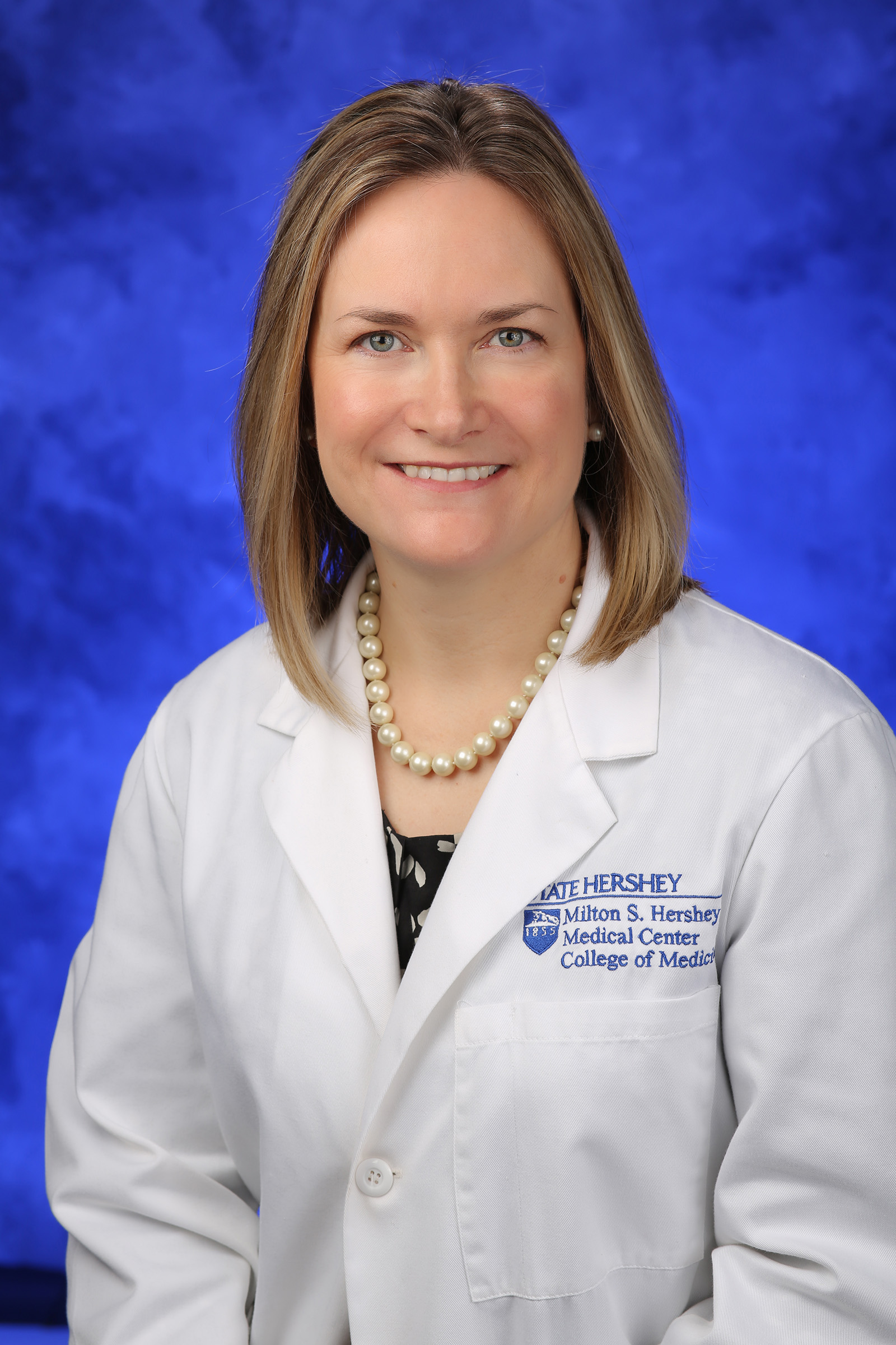 A professional white coat photo of April Armstrong