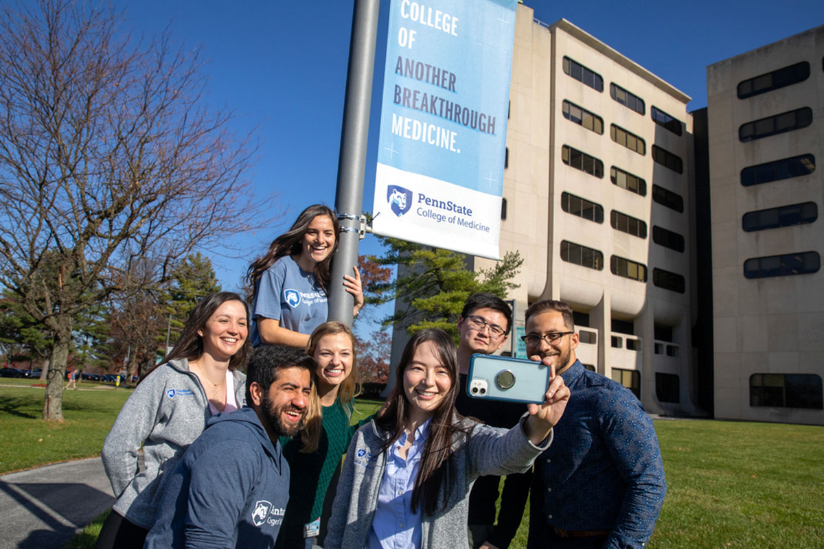 From left: Rosemarie Burynski, Aayushi Patel and Casandra Kyaw, first year medical students, pose with the Nittany Lion for a photo during the Penn State College of Medicine White Out event on Friday, Sept. 22, 2023.