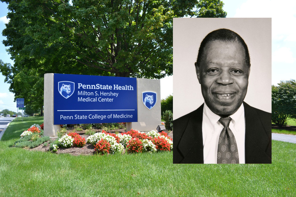 Photo of an outdoor space with flowers, grass, and a tree, along with blue and white sign that reads “Penn State Health Milton S. Hershey Medical Center, Penn State College of Medicine” and a photograph of Dr. Alphonse Leure-duPree, former associate dean of academic achievement and professor emeritus.