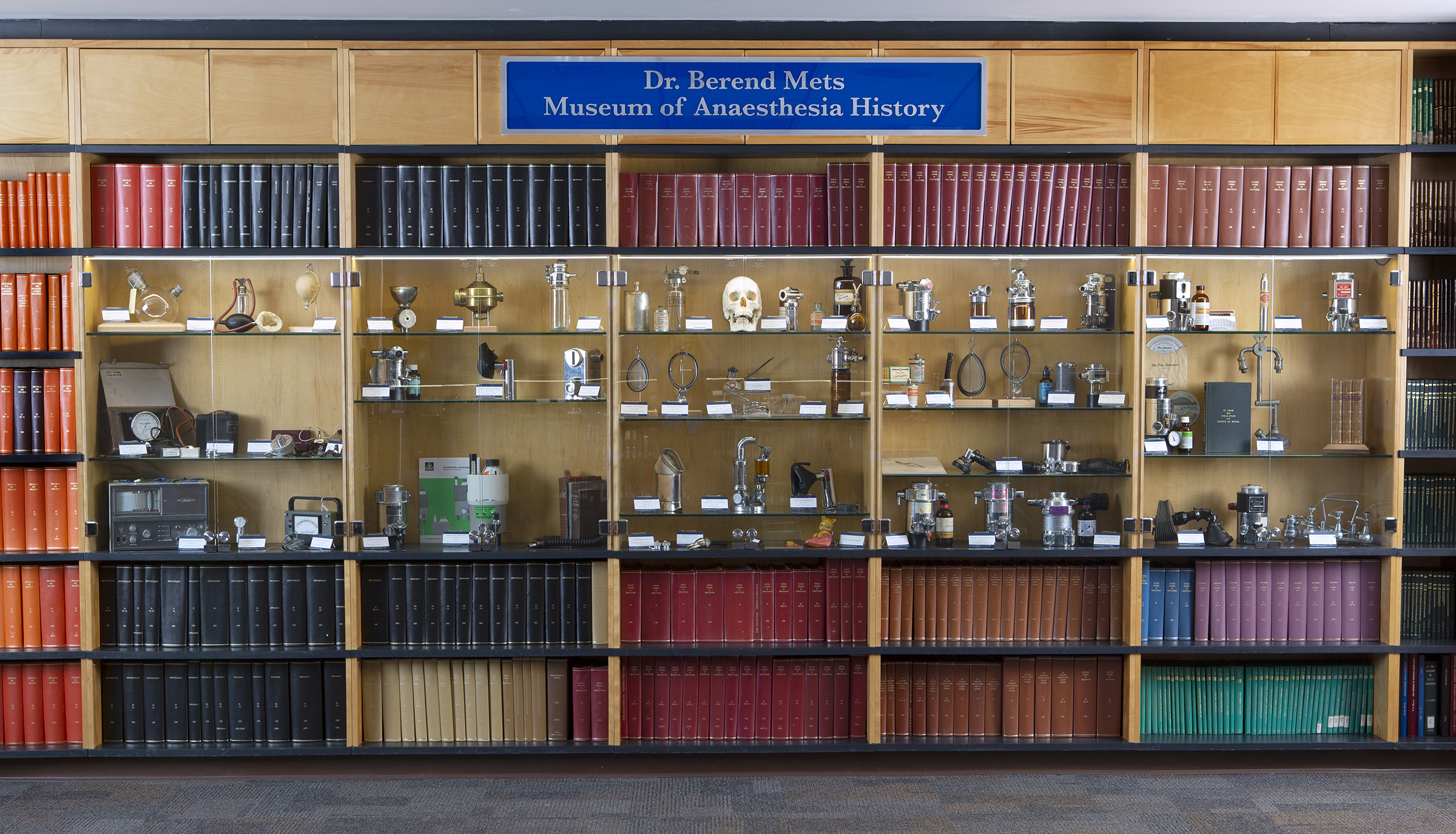 Display of shelves containing historical anesthesiology items and old books with Dr. Berend Mets Museum of Anaesthesia History above it.
