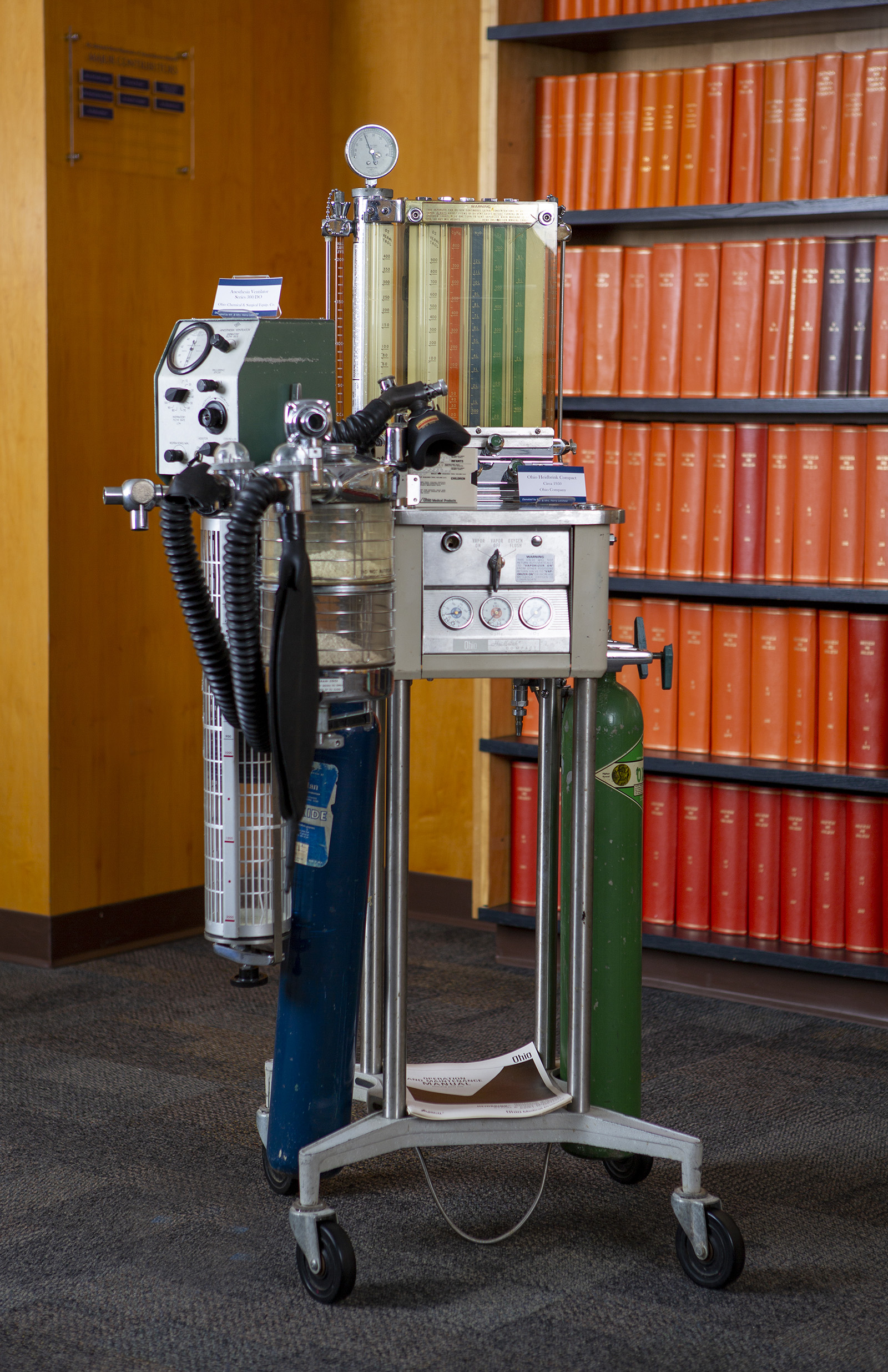 Ohio Kinet-O-Meter machine stands in a museum with a shelf of books behind it at right.