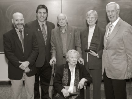 Lois W. Forney seated in a wheelchair with five people standing behind her