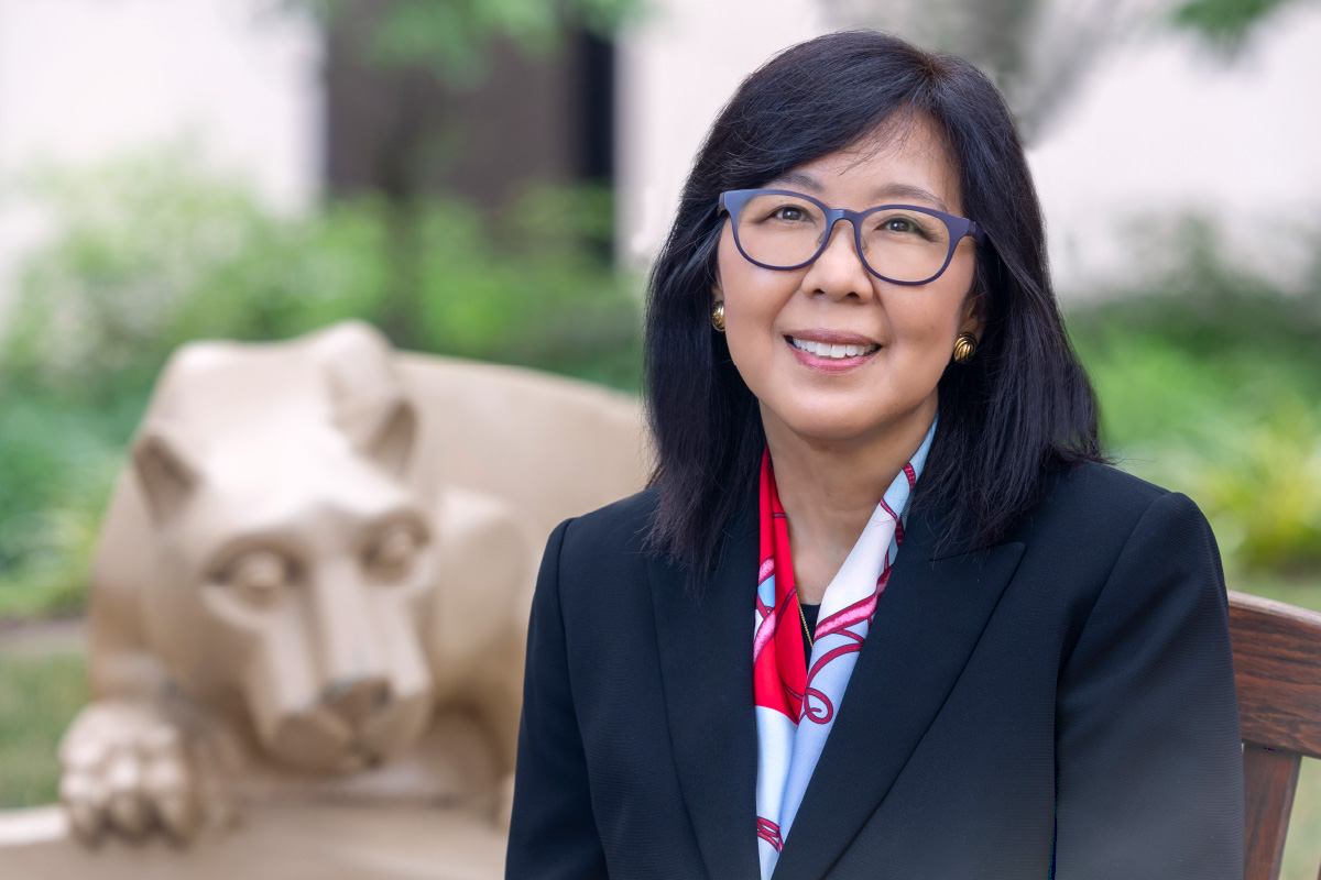 Dr. Karen Kim with the Nittany Lion statue behind her in the Penn State College of Medicine courtyard